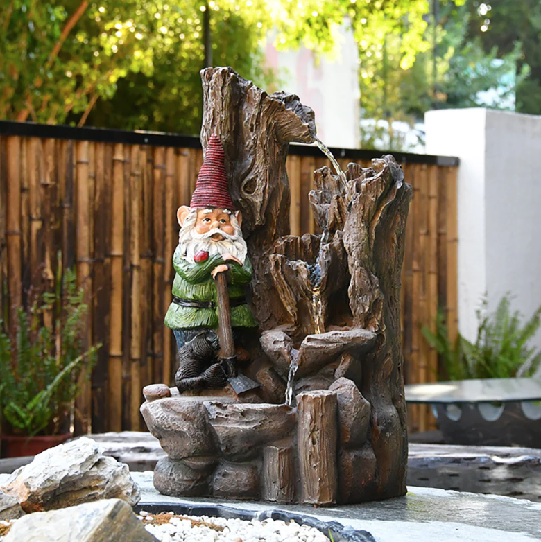 Gnome sitting outside on a water fountain