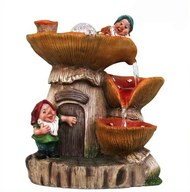 Two gnomes sitting on a tabletop water fountain